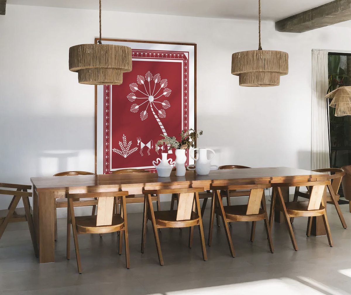 Warli canvas in a rosewood frame anchoring a wooden dining table